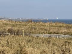 The mouth of the Tyne in the foreground, and St Mary's Lighthouse, north of Whitley Bay, in the distance